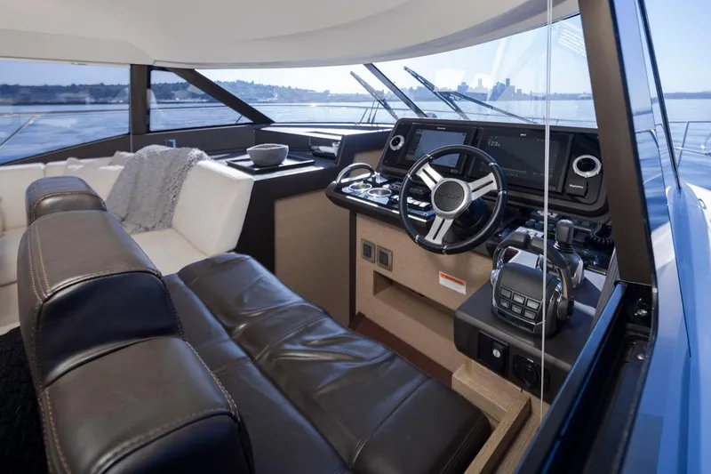 Four At Sea Yacht Photos Pics Luxurious interior of a 2019 Prestige 460 yacht with modern helm and leather seating.