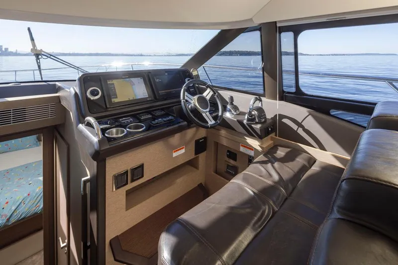 Four At Sea Yacht Photos Pics Interior of 2019 Prestige 460 yacht cockpit with navigation controls and leather seating.