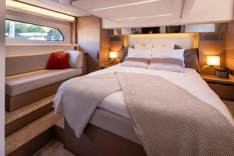 Four At Sea Yacht Photos Pics Luxurious bedroom interior of 2019 Prestige 460 yacht with cozy bedding and ambient lighting.