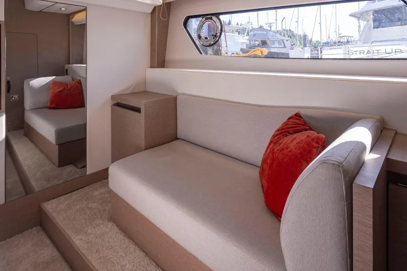 Four At Sea Yacht Photos Pics Luxurious interior of 2019 Prestige 460 yacht with beige sofa and red cushions.