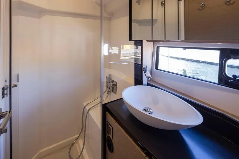 Four At Sea Yacht Photos Pics Modern bathroom interior on a 2019 Prestige 460 yacht, featuring sleek sink and shower.