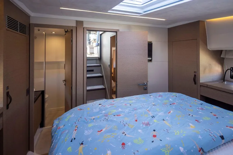 Four At Sea Yacht Photos Pics Luxurious cabin interior of 2019 Prestige 460 yacht with colorful bedding and modern amenities.
