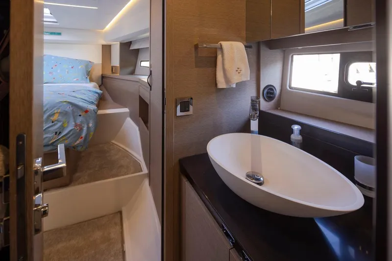 Four At Sea Yacht Photos Pics Luxurious interior of 2019 Prestige 460 yacht featuring a modern bathroom and cozy bedroom.