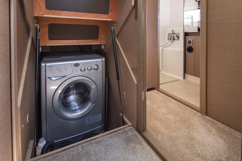 Four At Sea Yacht Photos Pics Laundry area with washing machine inside a 2019 Prestige 460 yacht.