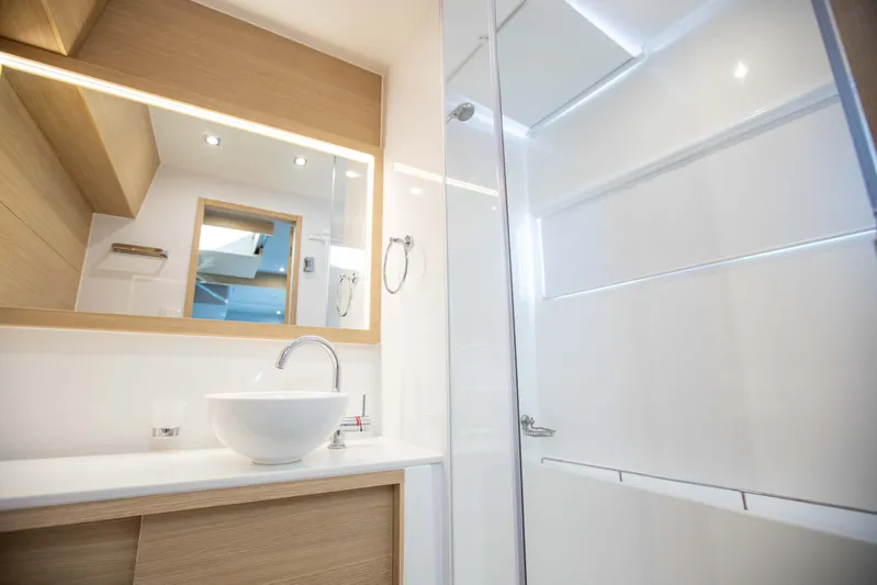  Yacht Photos Pics Modern bathroom interior on 2023 Aquila 54 Yacht, featuring sleek design and elegant fixtures.