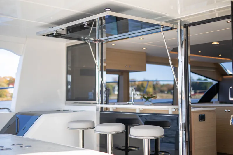  Yacht Photos Pics Luxurious interior of 2023 Aquila 54 Yacht with modern bar and seating area.