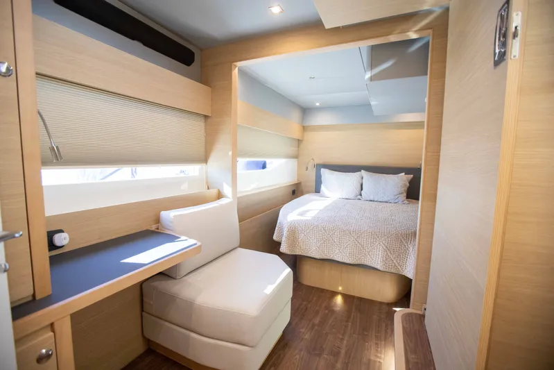  Yacht Photos Pics Luxurious interior of 2023 Aquila 54 Yacht with modern bedroom and seating area.