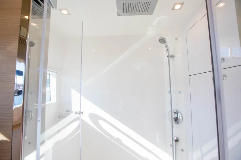  Yacht Photos Pics Luxurious shower area inside 2023 Aquila 54 Yacht, featuring modern fixtures and sleek design.
