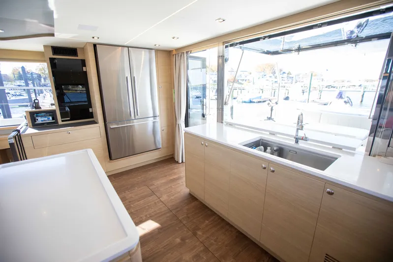  Yacht Photos Pics Modern kitchen interior of 2023 Aquila 54 Yacht with stainless steel appliances.