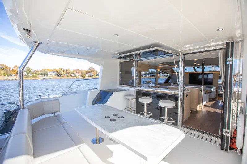  Yacht Photos Pics Luxurious 2023 Aquila 54 Yacht interior with modern seating and open water view.