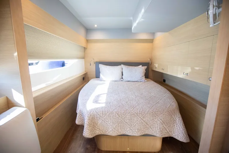  Yacht Photos Pics Luxurious bedroom interior of 2023 Aquila 54 Yacht with modern design and cozy bedding.