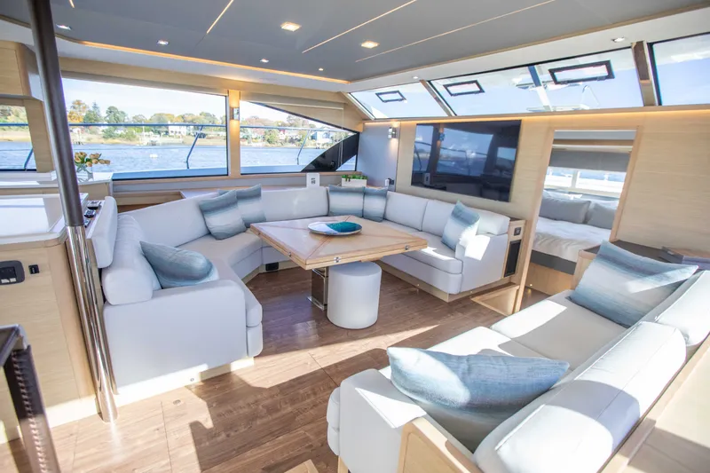  Yacht Photos Pics Luxurious interior of 2023 Aquila 54 Yacht with modern seating and panoramic windows.
