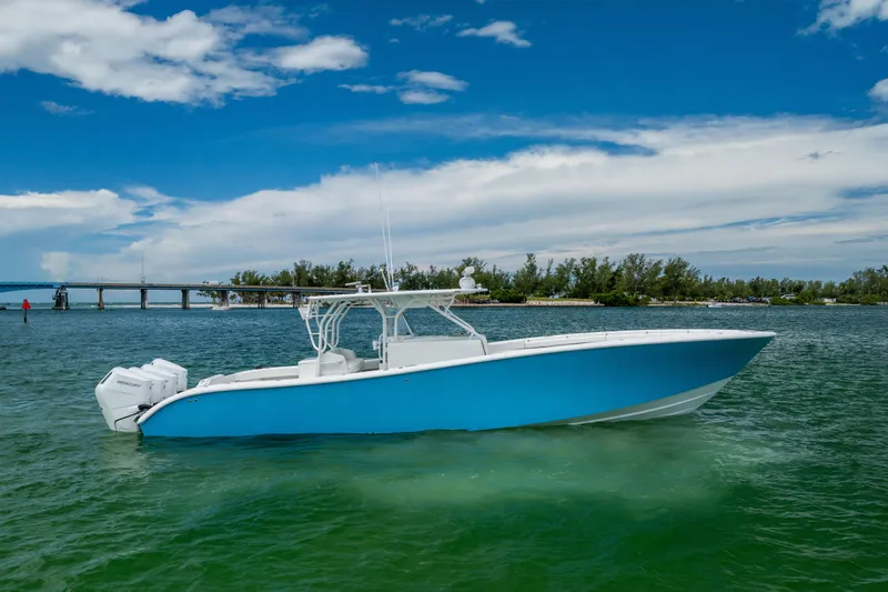  Yacht Photos Pics 2009 Yellowfin 42 Offshore boat on calm water under a blue sky.