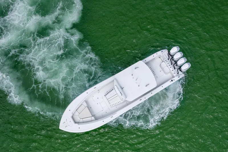  Yacht Photos Pics Aerial view of 2009 Yellowfin 42 Offshore boat cruising in green waters.