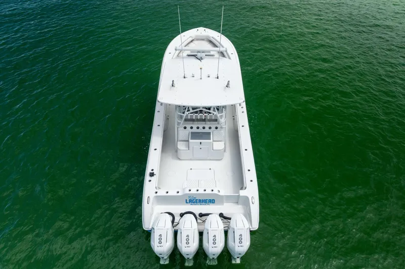  Yacht Photos Pics 2009 Yellowfin 42 Offshore boat with four engines on green water.