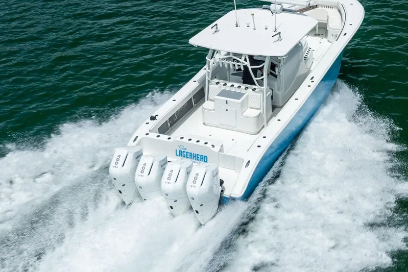  Yacht Photos Pics 2009 Yellowfin 42 Offshore boat cruising on open water with four powerful engines.