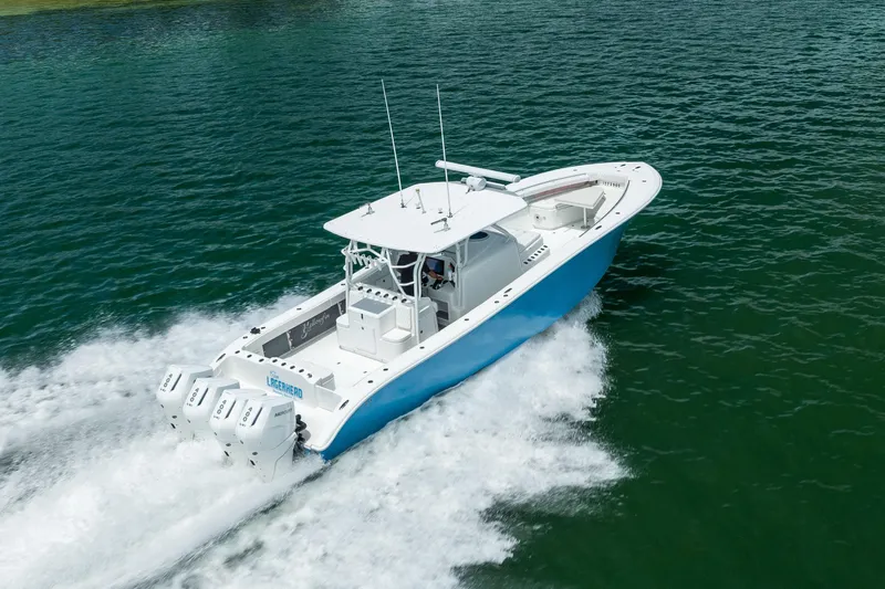  Yacht Photos Pics 2009 Yellowfin 42 Offshore boat cruising on open water, rear view.