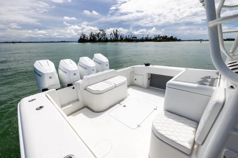  Yacht Photos Pics 2009 Yellowfin 42 Offshore boat with quad Mercury engines on calm water.