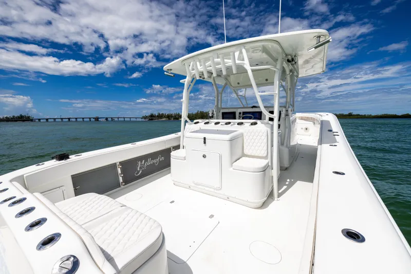  Yacht Photos Pics 2009 Yellowfin 42 Offshore boat on calm waters under a blue sky.