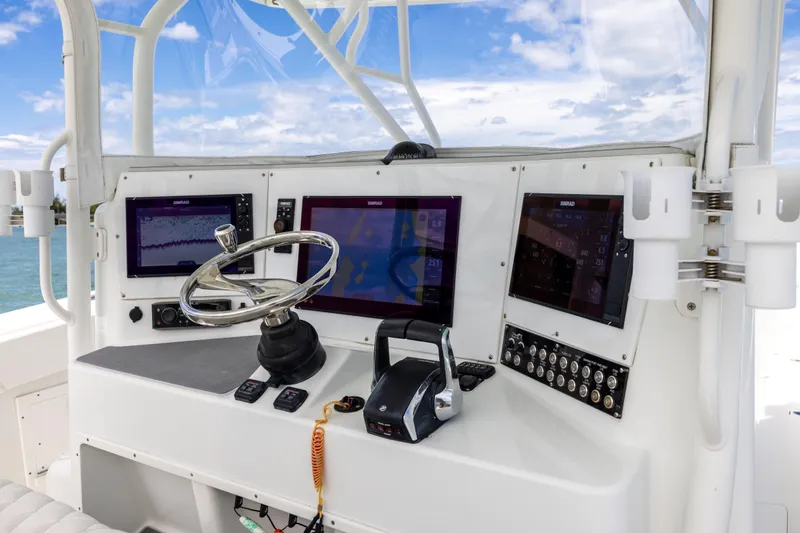  Yacht Photos Pics 2009 Yellowfin 42 Offshore boat dashboard with navigation screens and steering wheel.
