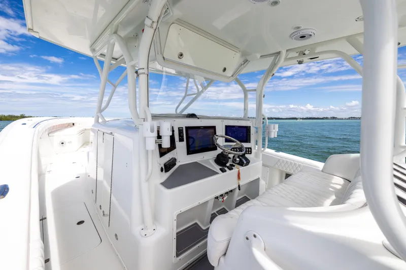  Yacht Photos Pics 2009 Yellowfin 42 Offshore boat cockpit with modern navigation equipment, cruising on open water.