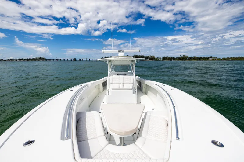  Yacht Photos Pics 2009 Yellowfin 42 Offshore boat on open water under a partly cloudy sky.