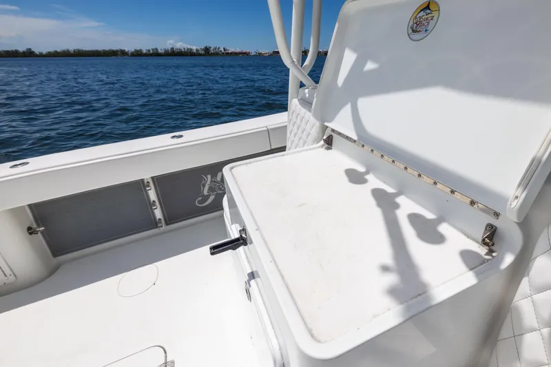  Yacht Photos Pics 2009 Yellowfin 42 Offshore boat interior with open storage compartment by the water.