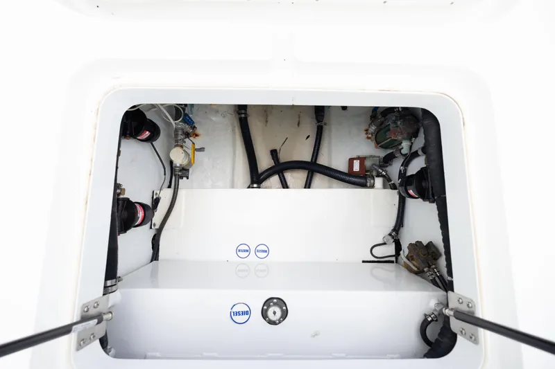  Yacht Photos Pics 2009 Yellowfin 42 Offshore boat compartment with visible hoses and mechanical components.