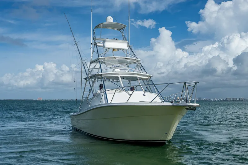  Yacht Photos Pics 2006 Topaz 32 Express boat on open water under blue sky.