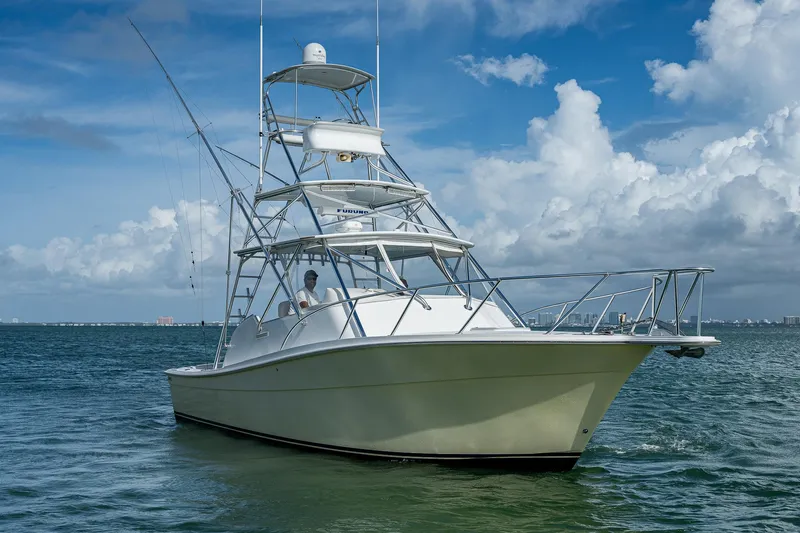  Yacht Photos Pics 2006 Topaz 32 Express boat on open water under blue sky.