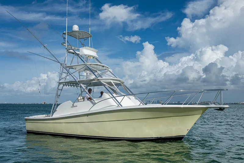  Yacht Photos Pics 2006 Topaz 32 Express boat on calm waters under a blue sky.