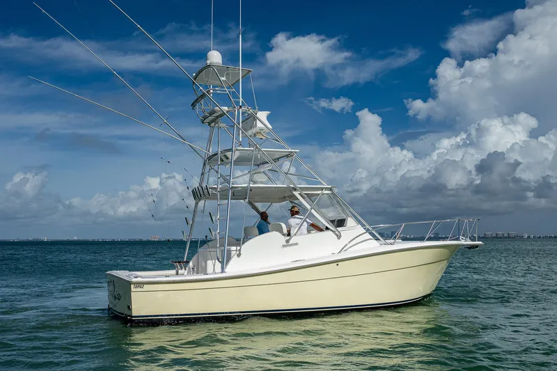  Yacht Photos Pics 2006 Topaz 32 Express boat on calm ocean waters under a blue sky.