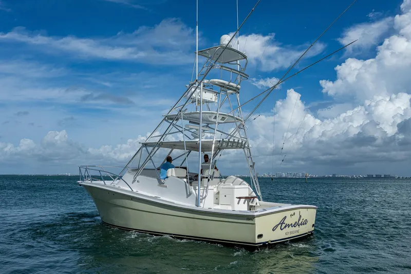  Yacht Photos Pics 2006 Topaz 32 Express boat on open water under a blue sky.