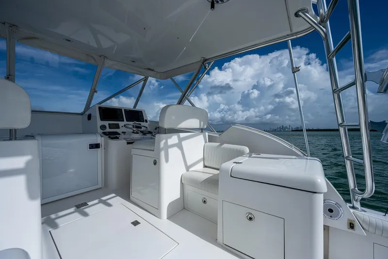  Yacht Photos Pics 2006 Topaz 32 Express boat interior with helm station and seating, ocean view.