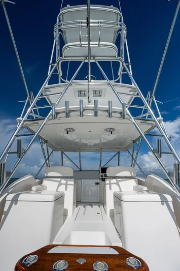  Yacht Photos Pics 2006 Topaz 32 Express boat with tower against blue sky.