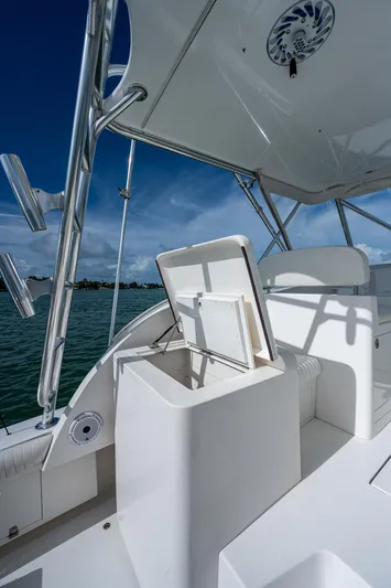  Yacht Photos Pics 2006 Topaz 32 Express boat with open storage compartment on deck.