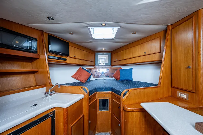  Yacht Photos Pics 2006 Topaz 32 Express boat interior with kitchenette, bed, and TV.