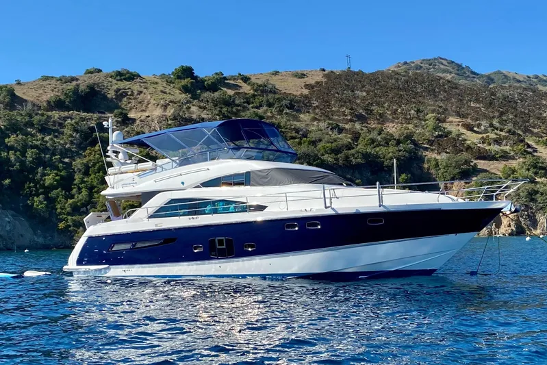 Casa Amigos Yacht Photos Pics Luxury 2010 Fairline Squadron yacht anchored near scenic coastline.