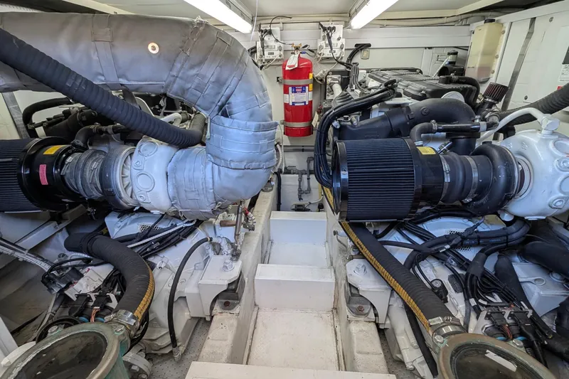 Casa Amigos Yacht Photos Pics Engine room of a 2010 Fairline Squadron yacht, featuring dual engines and a fire extinguisher.
