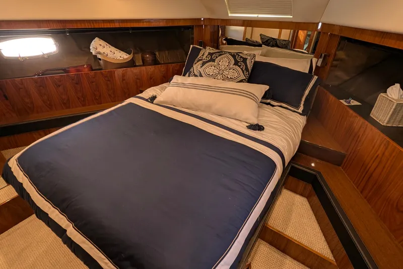 Casa Amigos Yacht Photos Pics Luxurious cabin interior of 2010 Fairline Squadron yacht with elegant bedding and wood paneling.