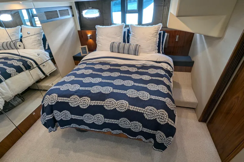 Casa Amigos Yacht Photos Pics Luxurious cabin interior of 2010 Fairline Squadron yacht with nautical-themed bedding.