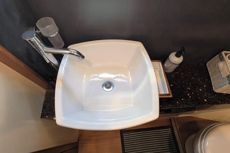 Casa Amigos Yacht Photos Pics Modern bathroom sink on Fairline Squadron 2010 yacht, featuring sleek faucet and countertop accessories.