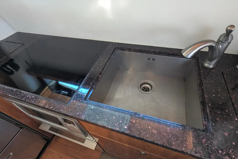 Casa Amigos Yacht Photos Pics Modern kitchen sink and stovetop in 2010 Fairline Squadron yacht.