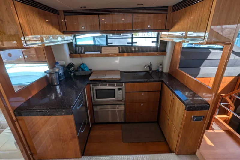 Casa Amigos Yacht Photos Pics Luxurious 2010 Fairline Squadron yacht kitchen with modern appliances and sleek wood cabinetry.