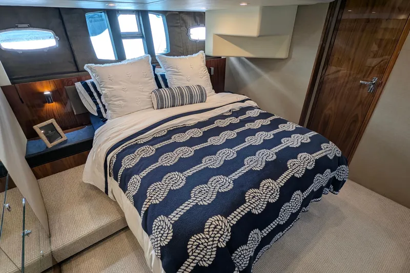Casa Amigos Yacht Photos Pics Luxurious cabin interior of 2010 Fairline Squadron yacht with nautical-themed bedding.