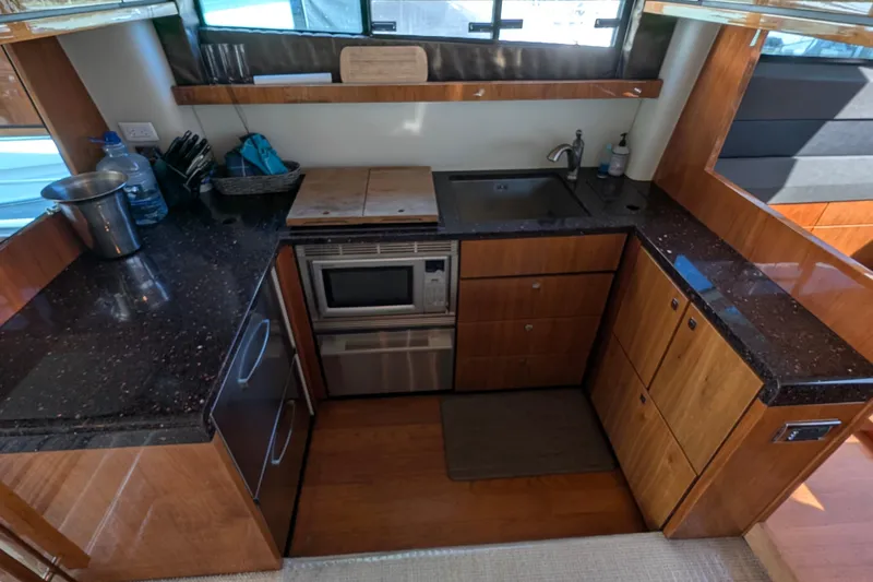 Casa Amigos Yacht Photos Pics Luxurious 2010 Fairline Squadron yacht kitchen with modern appliances and sleek wood cabinetry.