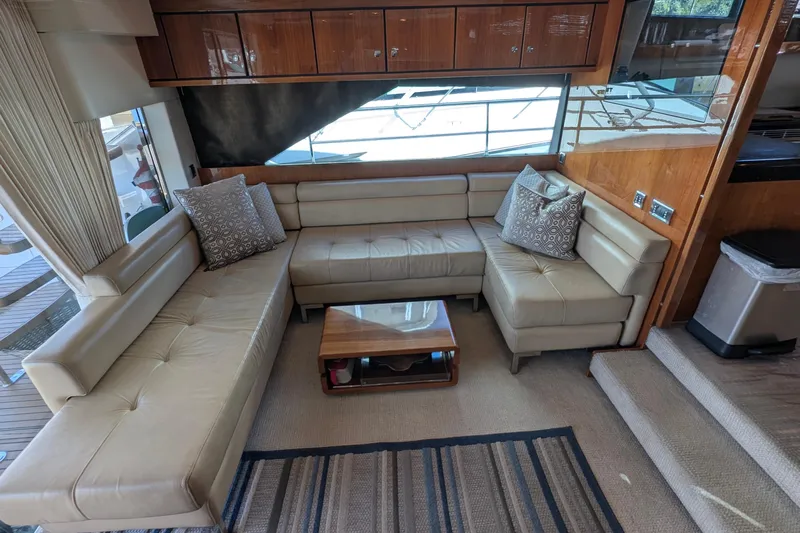 Casa Amigos Yacht Photos Pics Luxurious 2010 Fairline Squadron yacht interior with beige leather seating and wooden accents.