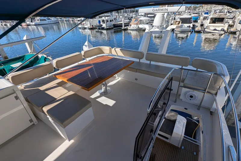 Casa Amigos Yacht Photos Pics Luxurious 2010 Fairline Squadron yacht deck with seating and table, docked at marina.