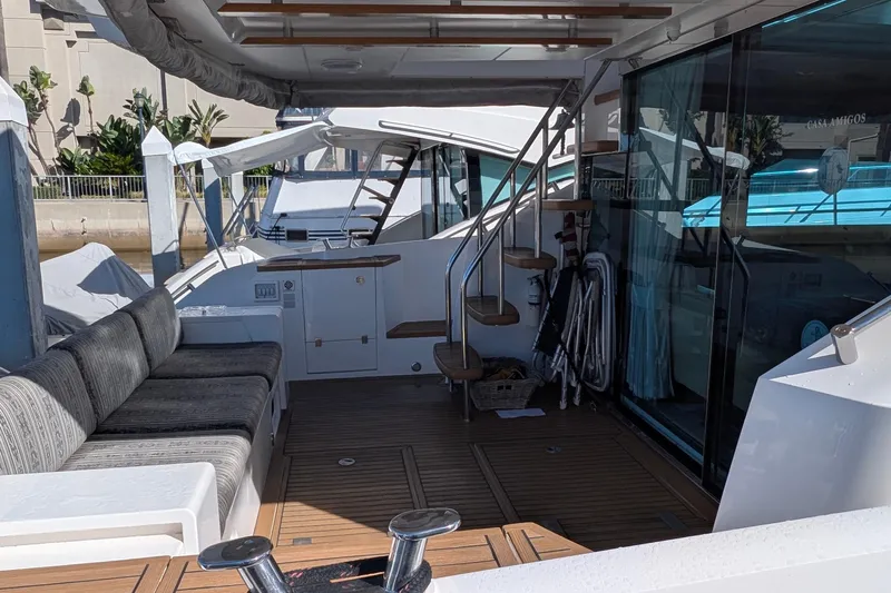 Casa Amigos Yacht Photos Pics Luxurious 2010 Fairline Squadron yacht deck with seating and stairs, docked in a marina.