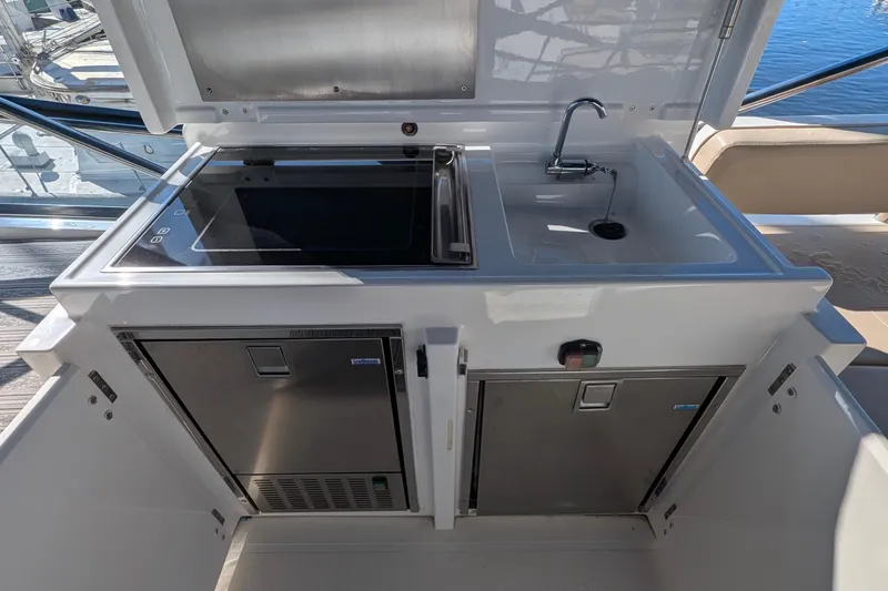 Casa Amigos Yacht Photos Pics Outdoor kitchen on 2010 Fairline Squadron yacht with sink and stove.